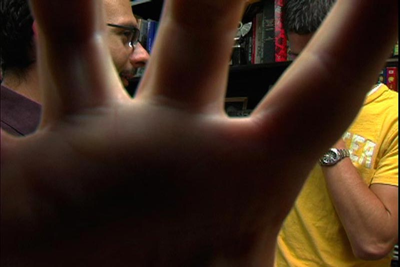 Filmmaker Chris Hansen puts his hand over the camera lens